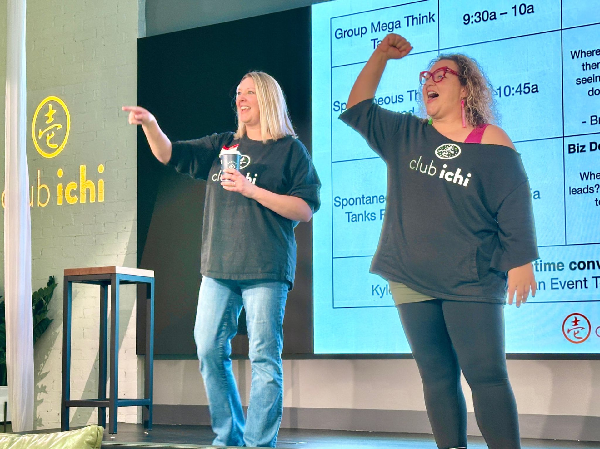 Liz and Nicole on stage in Club Ichi sweatshirts, mid-session.
